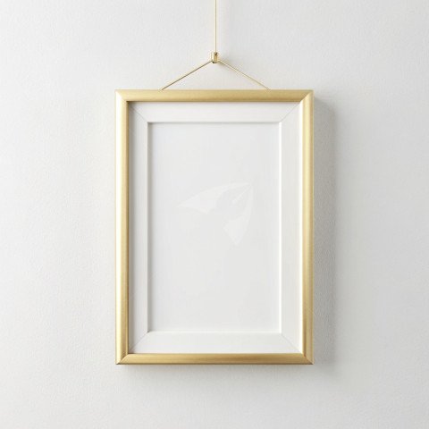 Golden photo frame mockup hanging on a plain white background